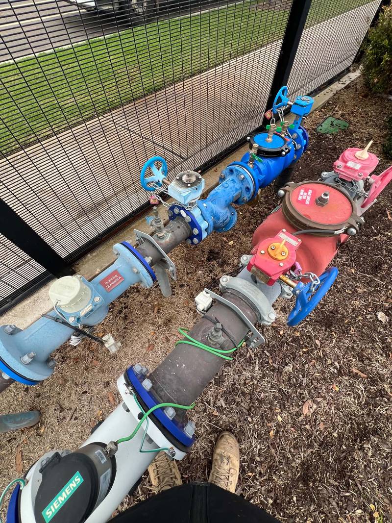 Commercial incoming water service with backflow protection and fire main, test cocks, meters and compliance tags fitted